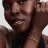 Armband mit rundem Verschluss und Flügelkette, 14-karätig vergoldet Armband mit rundem Verschluss und Flügelkette, 14-karätig vergoldet